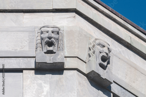 Ornamental bas-reliefs on the marble facade of a building of fascist architecture