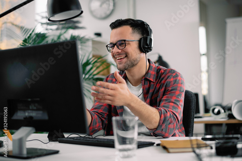 Businessman on video call. Handsome man in office with headphones. 