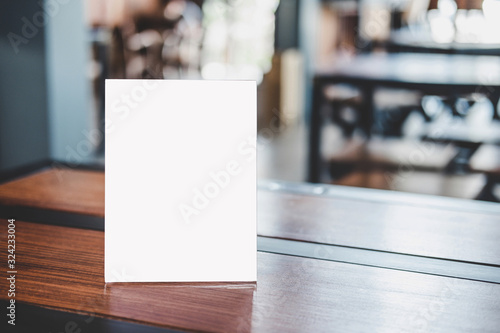 Mock up acrylic frame posters pattern template forms background, blank menu frame on table in coffee shop stand for your text of display your product