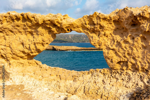 Hole in rock near Fourni beach on Rhodes island, Greece
