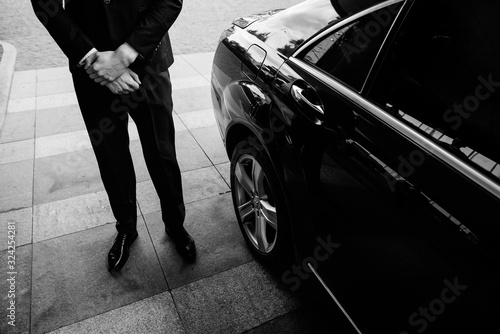 Valet's Hand Opening Grey Car Door On Street