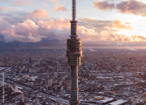 Ostankino television tower against the background of the winter city of Moscow from above, in the frame a winter city and streets, aerial photo