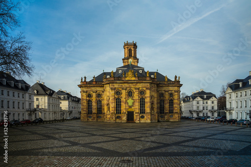 Germany, Beautiful cathedral ludwigskirche and ludwigs square in downtown saarbruecken city with clouds, sun and blue sky