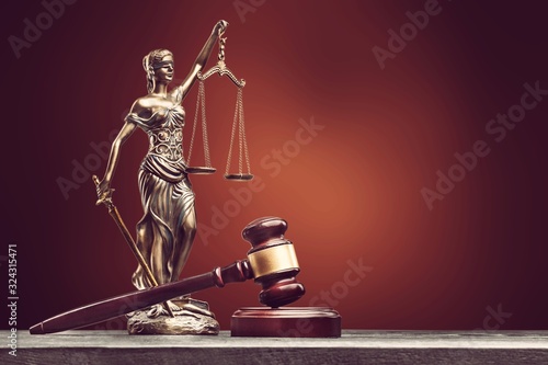 Statue of the lady of justice with scales and wooden gavel
