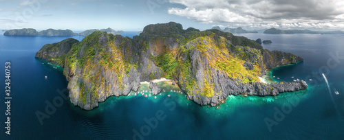 Aerial drone view of tourist boats around the beautiful lagoons in El Nido, Palawan