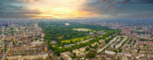 Beautiful aerial view of the Hyde park in London, UK. Magical sunset view over the park with London skyline on the horizon.