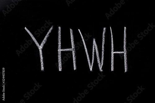 YHWH written in chalk on chalkboard