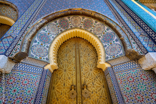 Upright view at the golden palace door with ornamental decorations in Fes, Morocco