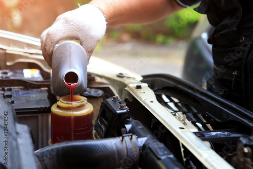 A hand filling car power steering fluid