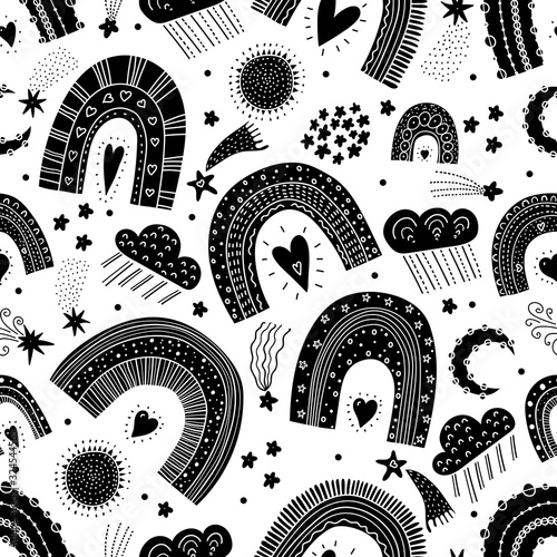 Black seamless pattern with magic rainbows, stars and clouds. Can be used in textile industry, paper, background, scrapbooking.