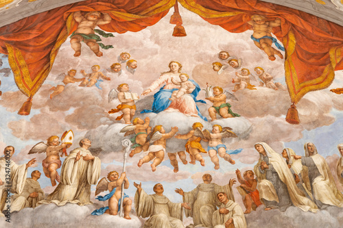 FERRARA, ITALY - JANUARY 30, 2020: The fresco of Madonna among the Benedictine saints in apsida of church Basilica di San Giorgio fuori le mura by Francesco Ferrari 18. cent.