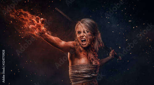 Fantasy woman warrior wearing rag cloth stained with blood and mud in the heat of battle. Cosplayer as Ciri from The Witcher