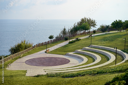 Lara city park with blue sky and sea. Modern amphitheatre. Broadwalk in Antalya, Turkey.