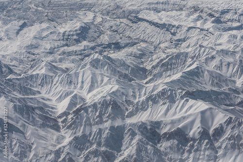 Snowed mountain tops aerial landscape view.