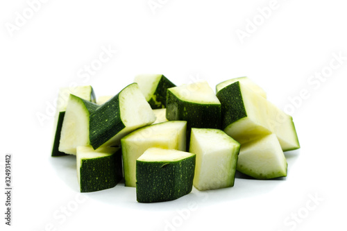 zucchini cubes isolated on white background