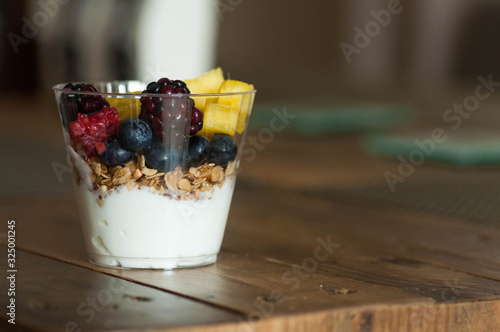 Yogurt parfait with fruits on table