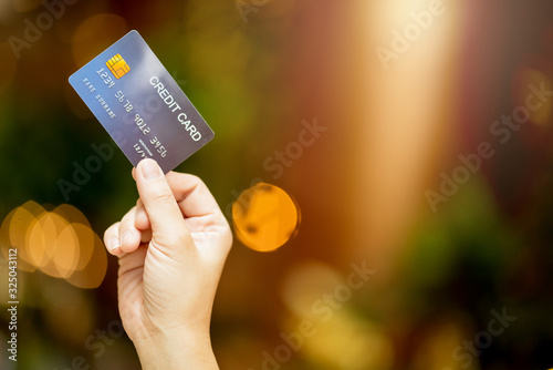 business shopping merchant ideas concept Close up of woman hand holding credit card for shopping with abstract blur mall background