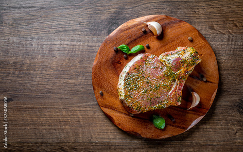 Raw Pork Loin chops marinated meat Steak for bbq on wooden table background