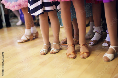 Children's legs in a ballroom dancing shoes ready to dance competition