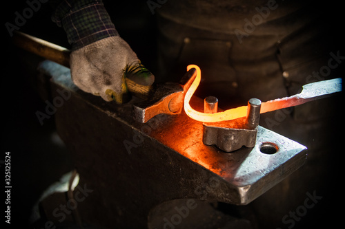 A man blacksmith making a unique handle for the knife