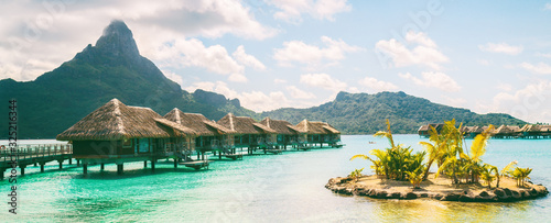 Bora Bora French Polynesia luxury hotel resort overwater bungalow suites in Tahiti, Honeymoon travel destination header panorama background.