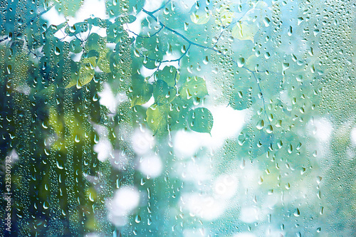 summer rain wet glass / abstract background landscape on a rainy day outside the window blurred background