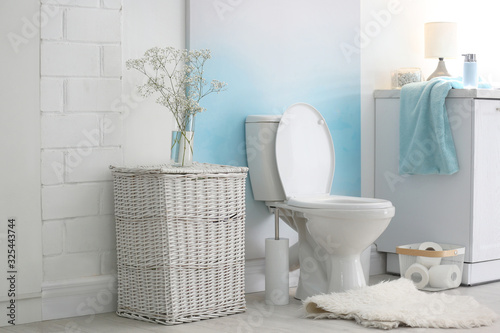 Modern toilet bowl in stylish bathroom interior