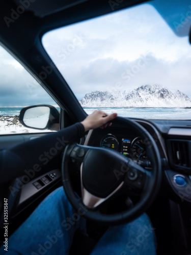 Driver at the wheel of a car. The view from inside the car on the road and landscape. Composition with transport. Travel - image