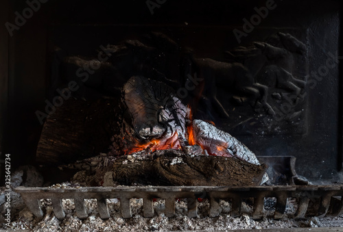 The firewood burning in fireplace