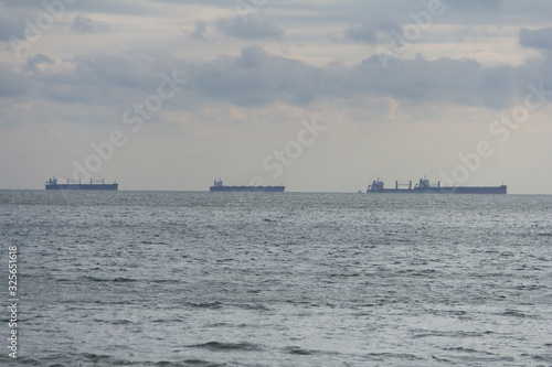 tanker, barge on the horizon, in the ocean bay
