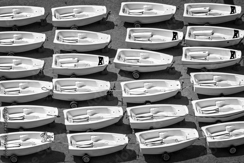 Aerial view of Optimist dinghies aligned. Sailing school boats in black and white