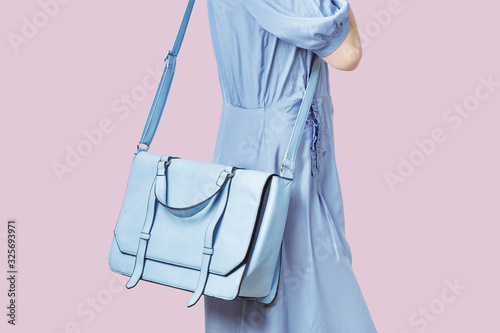 Woman carrying a blue messenger leather bag