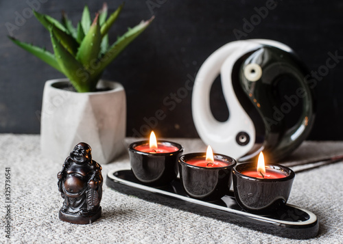 Composition with Buddhist symbols: yin yang, turtles, elephants, aroma candles, rosaries and bells. feng shui and zen concept