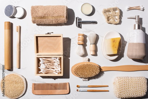 Top view of hygiene items on white background, zero waste concept