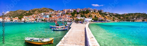 Traditional colorful Greece - travel in beautiful Samos Island, scenic Pythagoion town. view with traditional boats