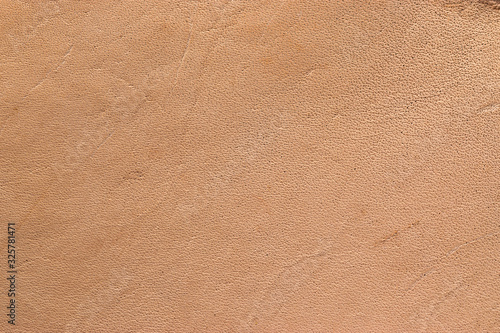 Natural vegetable tanned leather closeup macro full frame texture showing top grain and scratch wear marks