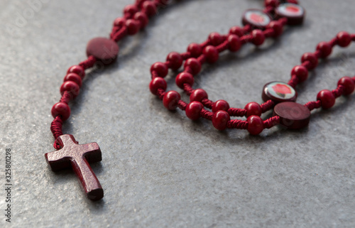 Red rosary on a stone background