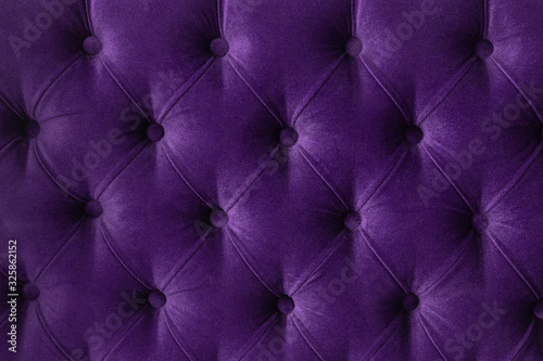 Quilted velour buttoned purple violet color fabric wall pattern background. Elegant vintage luxury sofa upholstery. Interior plush backdrop
