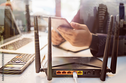 with business man using a computer in home office background . Computers and Router wireless broadband Accessories concept