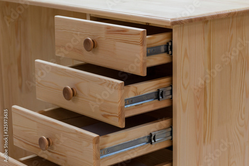 An open drawer of a desk. Classical writing desk with drawers.