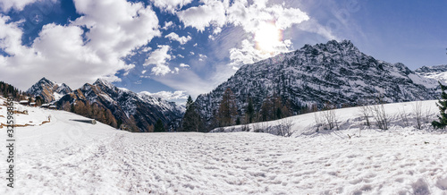 Panoramic view in the snowy mountains of Valsesia taken from the Otro valley, during a sunny day near the town of Alagna, Italy - February 2020.