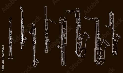 White outline various musical instruments, the contour of clarinets, oboe, saxophones, bassoon and contrabassoon on a black background