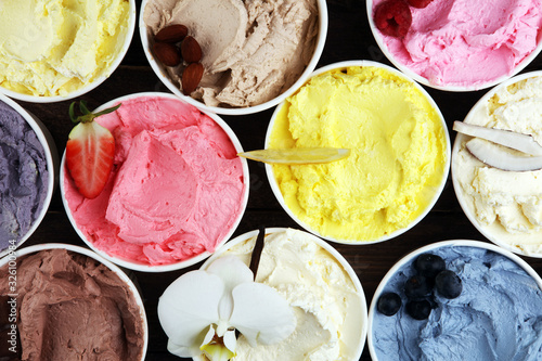 Various of ice cream flavor whit fresh blueberry, strawberry, kiwi, lemon, vanilla setup on rustic background . Summer and Sweet cold ice cream