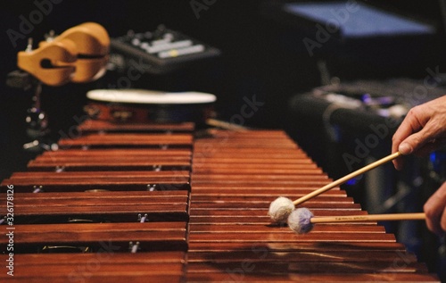 A man playing a marimba on a concert stage