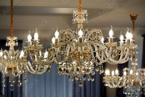 Luxury chandelier on the ceiling of a luxury restaurant. Selective focus.