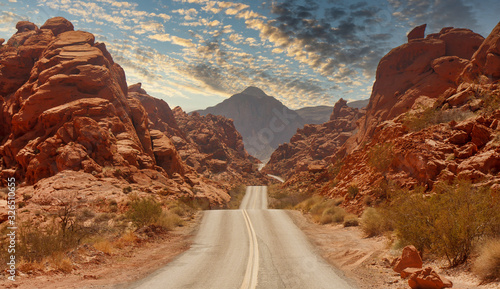 A highway rolling through red rock canyons in Nevada