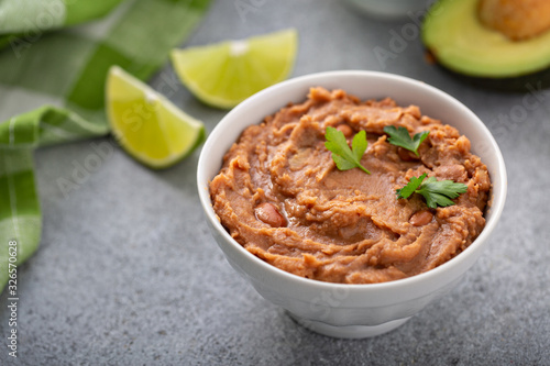 Refried beans in a white bowl, mexican dish