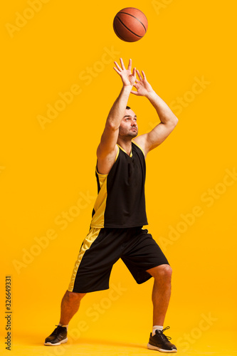 Front view of male basketball player dunking