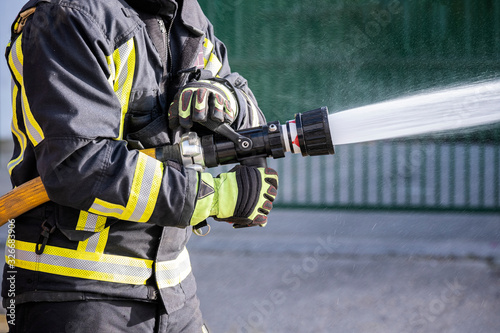 Firefighters who use fire extinguishers and hose water to fight fires