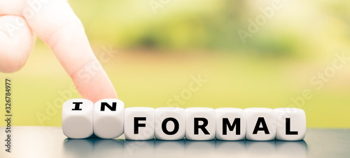 Hand turns a dice and changes the word "formal" to "informal".